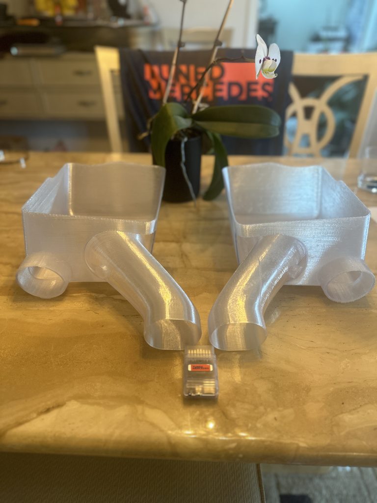 TunedMercedes air intake pictured one half in black other in clear polycarbonate plastic